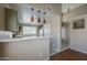 View of kitchen with white countertops, green cabinets and access to the living room at 823 W Bradford Dr, Gilbert, AZ 85233