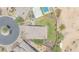Overhead view of backyard, with a pool, trampoline, lush lawn, mature landscaping, and privacy at 9017 E June Cir, Mesa, AZ 85207