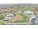 Aerial view of community park area including playground, picnic spots, green area and a community pool in the distance at 9017 E June Cir, Mesa, AZ 85207