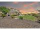 Expansive backyard with lush lawn and manicured landscaping at sunset at 9017 E June Cir, Mesa, AZ 85207