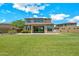 Expansive backyard features a lush lawn and covered patio, perfect for outdoor entertaining at 9017 E June Cir, Mesa, AZ 85207
