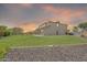 Large backyard with green grass that stretches from the edge of the house to a wall with nice stones at 9017 E June Cir, Mesa, AZ 85207