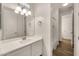 Bathroom with modern vanity, decorative lighting, and wood-look tile flooring at 9017 E June Cir, Mesa, AZ 85207