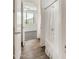 Bathroom hallway featuring wood-look tile flooring and a view of the tub and shower at 9017 E June Cir, Mesa, AZ 85207