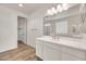 Bright bathroom featuring double sinks, a large mirror, and tiled floors at 9017 E June Cir, Mesa, AZ 85207