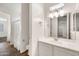 Bathroom with modern vanity, decorative lighting, and wood-look tile flooring at 9017 E June Cir, Mesa, AZ 85207