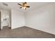 Bright bedroom featuring carpet and natural light from a large picture window at 9017 E June Cir, Mesa, AZ 85207