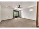 Spacious primary bedroom with a ceiling fan and sliding glass doors to the outside at 9017 E June Cir, Mesa, AZ 85207