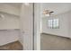 Walk-in closet with built-in shelving and an adjacent bedroom with lots of light at 9017 E June Cir, Mesa, AZ 85207