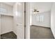 View into bedroom closet featuring carpeted floor, rod for hanging clothes, and ample space at 9017 E June Cir, Mesa, AZ 85207