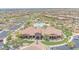 Aerial view of a recreation center featuring a pool, parking, green spaces, and desert landscaping at 9017 E June Cir, Mesa, AZ 85207