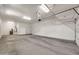 Spacious garage with ample lighting, epoxy flooring, and overhead storage racks at 9017 E June Cir, Mesa, AZ 85207