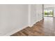 Inviting hallway with wood-look tile flooring leading to a bright and airy living space at 9017 E June Cir, Mesa, AZ 85207
