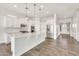 Bright white kitchen featuring a large island, stainless steel appliances, and ample cabinet space at 9017 E June Cir, Mesa, AZ 85207
