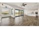 Spacious living room with wood-look tile and sliding glass doors to backyard at 9017 E June Cir, Mesa, AZ 85207