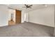 Spacious main bedroom with carpet and decorative sliding barn door to the bathroom at 9017 E June Cir, Mesa, AZ 85207