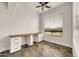 Bright office space with hardwood-style tile flooring, built-in desk and a view to the outdoors at 9017 E June Cir, Mesa, AZ 85207