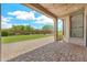 Covered patio with brick flooring and string lights, offering a cozy outdoor space at 9017 E June Cir, Mesa, AZ 85207