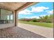 View of covered patio with pavers and string lights, overlooking a well-maintained backyard at 9017 E June Cir, Mesa, AZ 85207