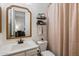 Cozy bathroom with neutral tones, decorative shelves, framed mirror, and shower with curtain at 9445 W Monte Lindo --, Peoria, AZ 85383