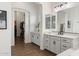 Bathroom featuring double sinks, white cabinets, and a walk-in closet at 9445 W Monte Lindo --, Peoria, AZ 85383