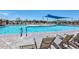 Inviting community pool with lounge chairs, a shade structure and a splashpad, for summer enjoyment at 9445 W Monte Lindo --, Peoria, AZ 85383