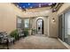 Inviting courtyard with brick flooring, stylish seating, and charming string lights overhead at 9445 W Monte Lindo --, Peoria, AZ 85383