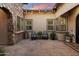 Relaxing courtyard featuring brick flooring, comfortable seating, and ambient string lights at 9445 W Monte Lindo --, Peoria, AZ 85383
