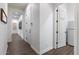 Hallway featuring wood-look floors and neutral tones, with access to a laundry room at 9445 W Monte Lindo --, Peoria, AZ 85383
