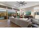 Open concept living room boasts large windows, sliding glass doors, and a comfortable sectional sofa at 9445 W Monte Lindo --, Peoria, AZ 85383