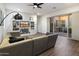 Comfortable living room with a large sectional sofa and sliding glass doors to an outdoor patio at 9445 W Monte Lindo --, Peoria, AZ 85383