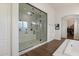 The main bathroom has a large walk-in shower, double sinks, and an arched doorway to the closet at 9445 W Monte Lindo --, Peoria, AZ 85383