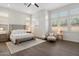 Bright main bedroom with a king-sized bed, plantation shutters, and wood-look floors at 9445 W Monte Lindo --, Peoria, AZ 85383