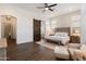The main bedroom features a king bed, shuttered windows, and a sliding barn door to the bathroom at 9445 W Monte Lindo --, Peoria, AZ 85383
