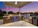 State-of-the-art outdoor kitchen with a built-in grill and bar area, perfect for al fresco dining at 9445 W Monte Lindo --, Peoria, AZ 85383