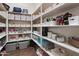Walk-in pantry has floor-to-ceiling shelving with ample storage for food and supplies at 9445 W Monte Lindo --, Peoria, AZ 85383