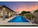 Stunning backyard pool with a tranquil waterfall feature and comfortable lounge area at 9445 W Monte Lindo --, Peoria, AZ 85383