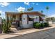 Inviting home exterior with desert plants, covered porch, and neutral tones, offering a warm curb appeal at 9501 E Broadway Rd # 168, Mesa, AZ 85208