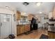 Functional kitchen with wood cabinets, black appliances, and adjacent dining space at 9501 E Broadway Rd # 168, Mesa, AZ 85208