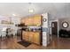 Well-lit kitchen featuring wooden cabinets, stainless steel appliances, and dining area at 9501 E Broadway Rd # 168, Mesa, AZ 85208