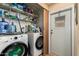 This laundry room features a washer, dryer, storage shelves, and a convenient access door to the outside at 9501 E Broadway Rd # 168, Mesa, AZ 85208