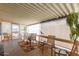 This covered patio has chairs, table and a music stand and provides a relaxing outdoor space with natural light at 9501 E Broadway Rd # 168, Mesa, AZ 85208