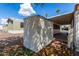 Exterior shot of a storage shed with a covered parking area, set amidst a landscaped yard with palm trees at 9501 E Broadway Rd # 168, Mesa, AZ 85208