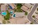 Aerial view of a home nestled in a vibrant neighborhood with a private pool, patio, and mature trees at 10261 W Foothill Dr, Peoria, AZ 85383