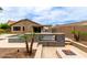 Backyard oasis features a pool, fire pit, covered patio, outdoor kitchen, and beautiful desert landscaping at 10261 W Foothill Dr, Peoria, AZ 85383
