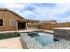 The backyard features a pool with water features, an outdoor kitchen and covered patio for entertaining outdoors at 10261 W Foothill Dr, Peoria, AZ 85383
