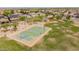 Aerial view of community basketball court surrounded by green grass and pedestrian trails at 10261 W Foothill Dr, Peoria, AZ 85383