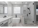 Elegant bathroom featuring a modern tub and glass-enclosed shower at 10261 W Foothill Dr, Peoria, AZ 85383