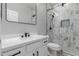 Modern bathroom features a stylish vanity, black accents, and a glass-enclosed shower with decorative tile at 10261 W Foothill Dr, Peoria, AZ 85383