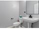 Modern powder bathroom with pedestal sink, perfect for guests at 10261 W Foothill Dr, Peoria, AZ 85383